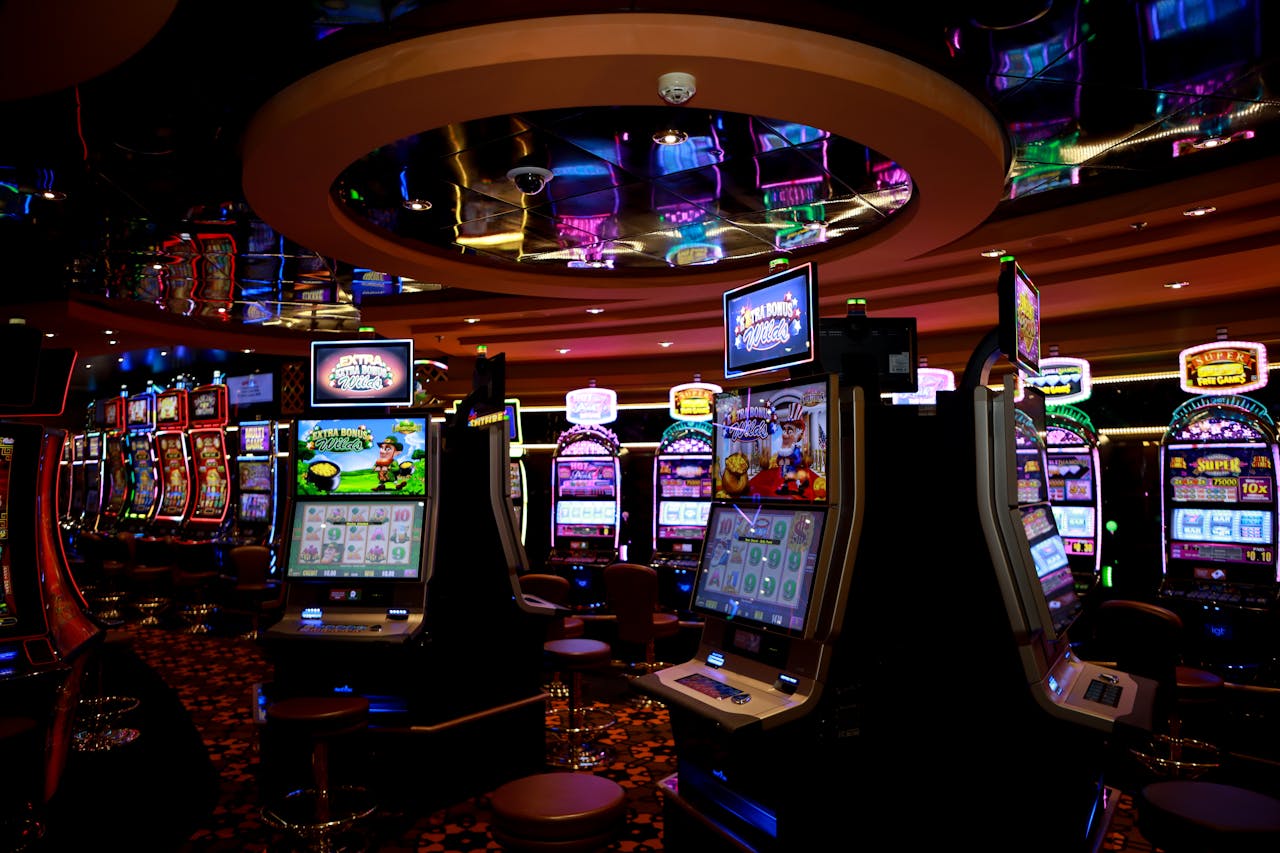 services-04 Vibrant casino floor with colorful slot machines and bright lights capturing a lively gaming atmosphere.