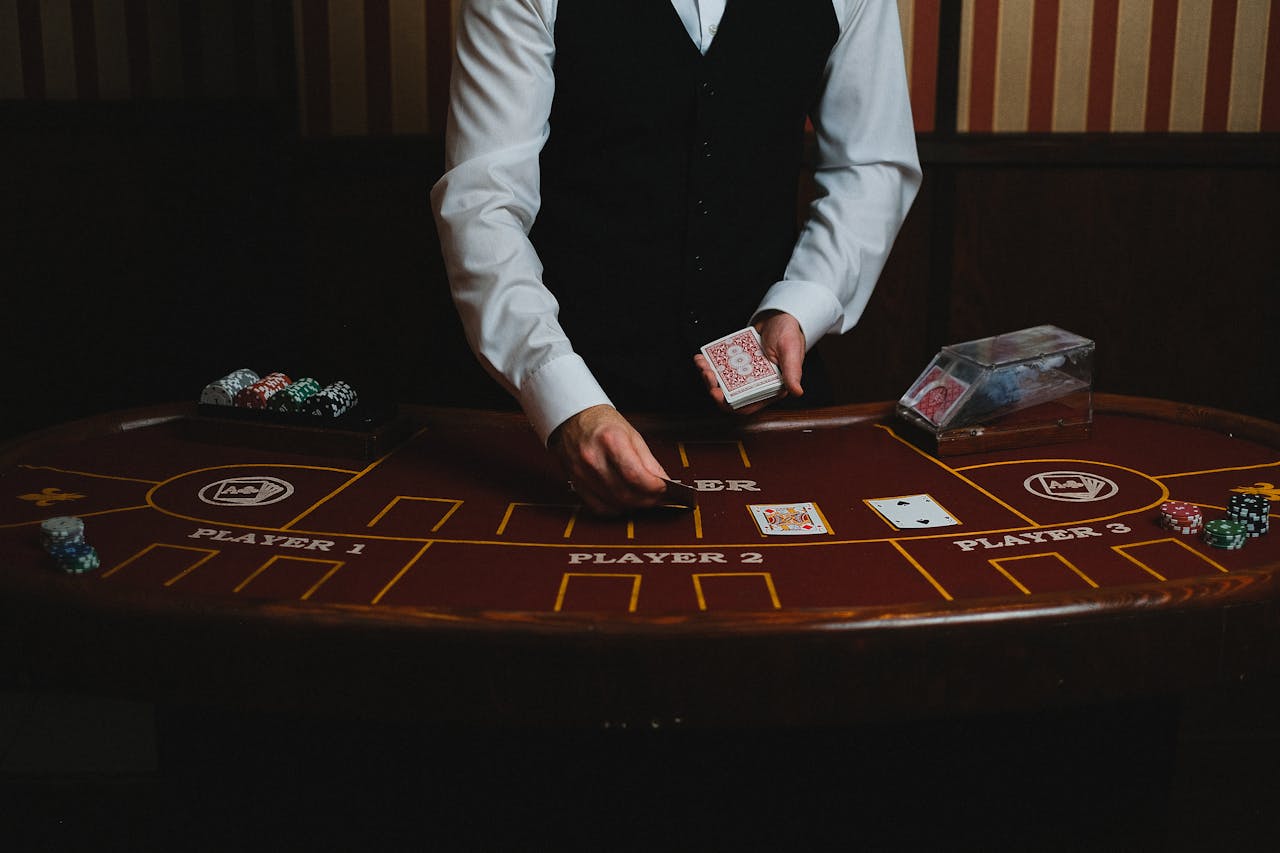 services-02 A casino dealer handling cards at a gaming table, ready for blackjack or poker.